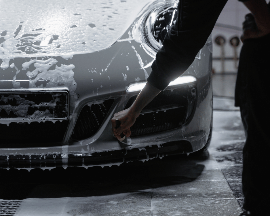 Foam wash on a vehicle front bumper during detailing service
